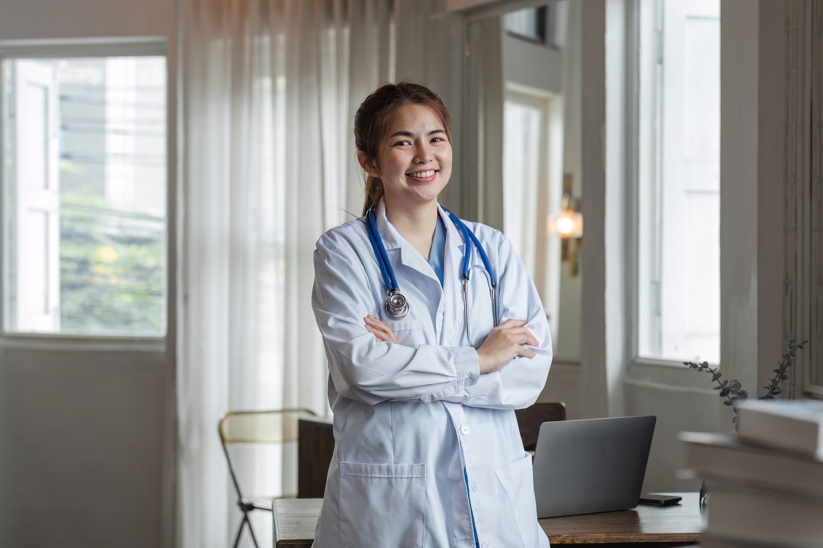 Smiling female doctor wearing a stethoscope in the doctor's office in the hospital